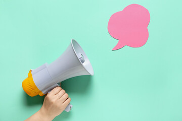 Woman with megaphone and speech bubble on color background