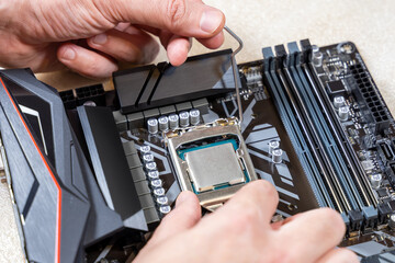 Installing a blank central processor on a motherboard. The blank CPU is installed in the...