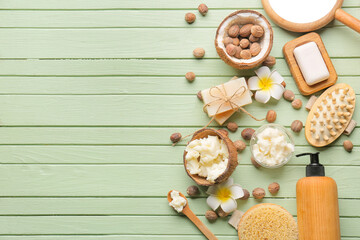 Fototapeta na wymiar Coconut shell with shea butter, nuts and bath supplies on color wooden background