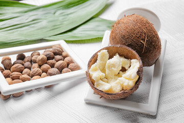 Composition with shea butter and nuts on light background