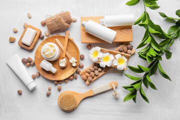 Composition with shea butter, nuts and bath supplies on light background