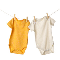 Baby clothes hanging on rope against white background