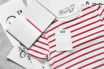 Composition with stylish t-shirt, calendar, notebook and greeting cards on light background, closeup