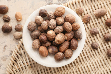 Bowl with shea nuts on grunge background