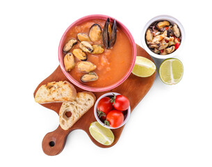 Bowl of tasty Cacciucco soup and ingredients on white background