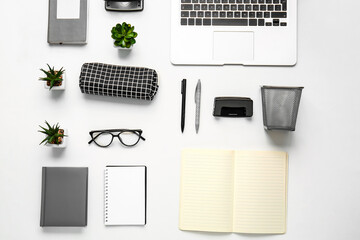 Composition with pencil case, stationery and laptop on white background, closeup