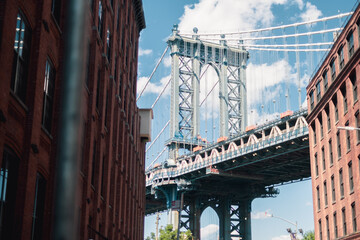 Brooklyn bridge framed by buildings in Dumbo.