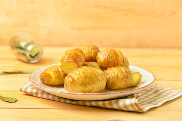 Plate with tasty baked potato on table