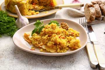 Plate with tasty Shah Pilaf on light background