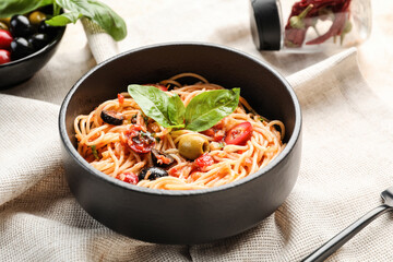 Bowl with tasty Pasta Puttanesca on table