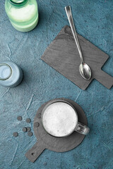 Glass cup of tasty Charcoal Latte on color background