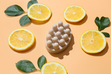 Massage soap bar and slices of lemon on color background, closeup
