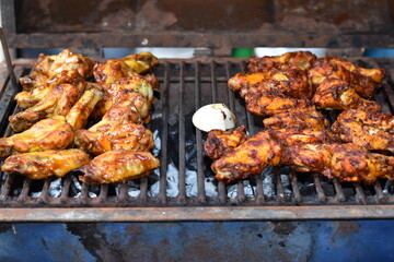 Cooking some marinated quail on the grill with charcoal