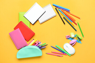 Frame made of stationery on color background