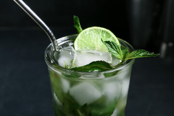 Glass of fresh mojito on dark background, closeup