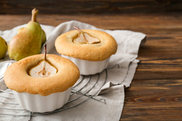 Grid with tasty pear pot pies on wooden background