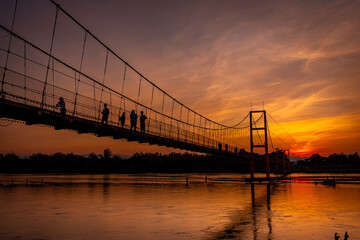 Obraz premium Suspension bridge in the beautiful twilight sunset