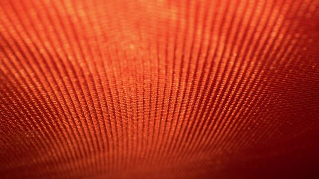 RACK FOCUSING inside the intricately decorative endpaper of a hard cover book. Lines and patterns of fabric material have really vivid colors. DEFOCUSED on top, rolling down to bottom and back again.