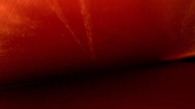 Pulling away diagonally from inside the decorative endpaper of a hard cover book starting near the spine. DEFOCUSED lines fade while following a V-shaped marking not inherent to the original material