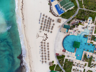 Seaside resort. Infrastructure. Hotels, swimming pools, lots of greenery, white sandy beach. Dark turquoise sea water. View from above. Aerial photograph. Tourist destinations, rest.