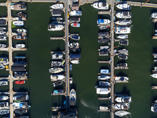Boat pier. There are many boats, yachts and other sea transport. Calm water. Calm. Boats, yachts. Luxurious life. Water tourism, recreation, weekend. Minimalism.