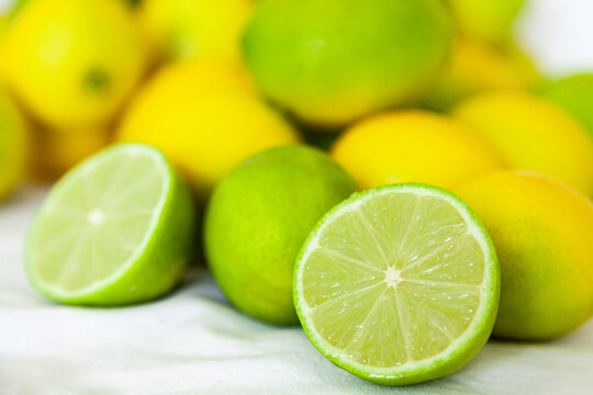 Fresh lime fruit harvest on white background, sliced open