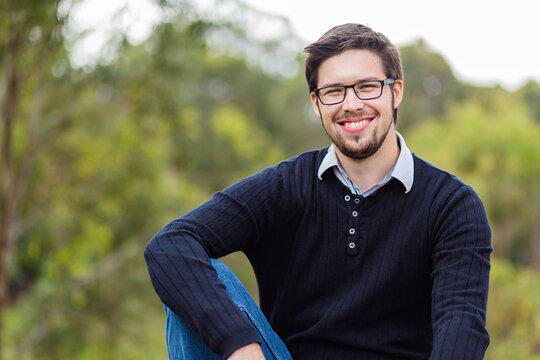 Portrait of smiling bearded man in his twenties outside