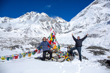 Father and son celebrate their arrival at Mt. Everest Base Camp. - obrazy, fototapety, plakaty