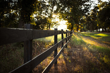 wooden fence in the country at sunset