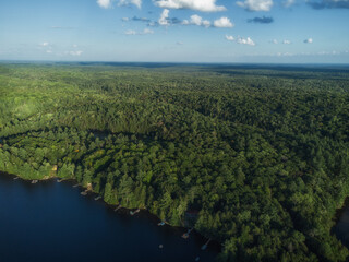 Aerial over Buckskin Lake on a late summer afternoon. Cottages in the expansive crown land wilderness in the Tory Hill, Highlands East, Ontario, Canada. © Atomazul