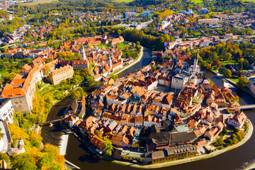 View from drone of historical houses of Czech city Cesky Krumlov in sunny fall day
