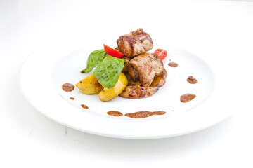 Dish with pork shish kebab of Georgian cuisine on a skewer with onions and fried potatoes in a rustic style with .tomato sauce. Isolated over white background
