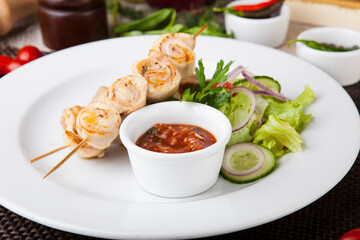 chicken skewers with grilled potatoes and tomato spicy sauce
