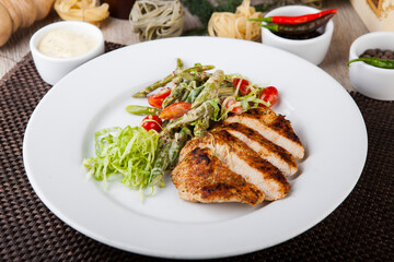 duck with asparagus in sauce and herbs with tomatoes
