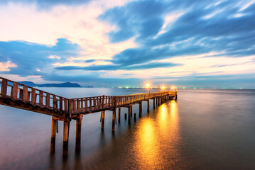 Obraz premium Summer, Travel, Vacation and Holiday concept - Wooden pier between sunset in Phuket, Thailand