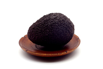 Whole avocado fruit and halves in a wooden plate isolated on white background with clipping path