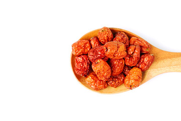 dried unabi fruit or jujube in wood spoon of  on white background. copy space for text.