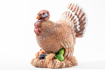 Vintage clay turkey against a white background. Seasonal display for Thanksgiving and Halloween.