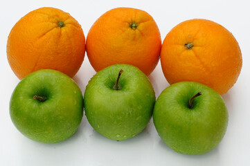close up of green apple and orange isolated on white background 