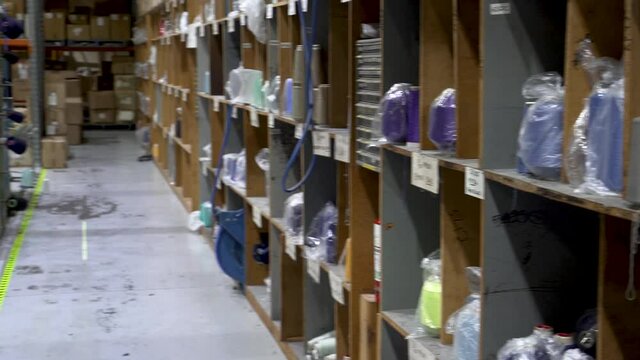 4K clip of Assorted colored nylon spools stored in industrial sock manufacturing plant