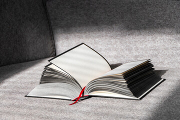 Black and White open Book with empty pages with red marker on gray simple background.