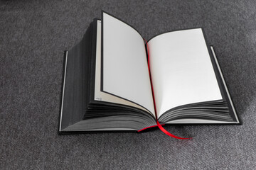 Black and White open Book with empty pages with red marker on gray simple background.