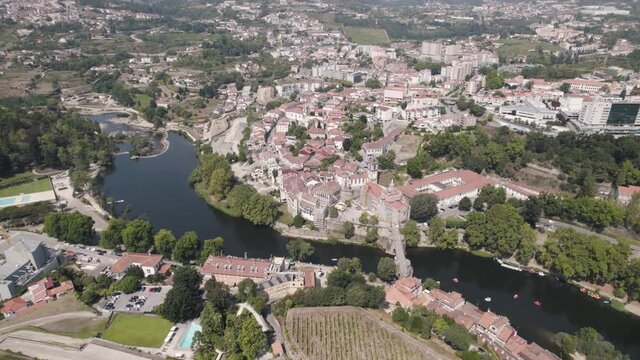 Establishing aerial above view of the historic parish townscape and famous Sao Goncalo church, Amarante.