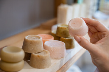 Woman chooses organic soap in eco friendly store.
