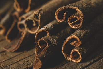 Close up of cinnamon sticks on wooden background