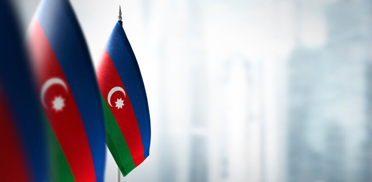 Small flags of Azerbaijan on a blurry background of the city