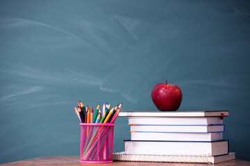 Pencils and book and blackboard. Education concept.