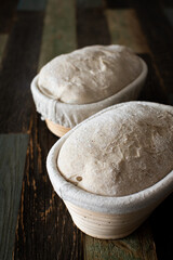 Bread dough in a rattan basket on a table made of wood