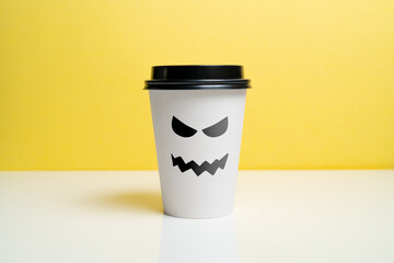 A craft coffee cup with a wicked smile. Halloween holiday.