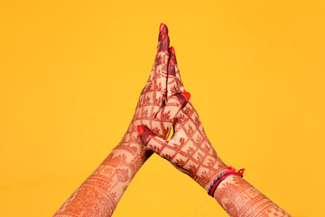 Beautiful henna or mehendi decoration on a hindu bride's hand & Feet | Isolated hand & feet with...